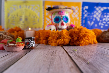Day of the Dead offering, with small candy decorations, candles, confetti, and skulls
