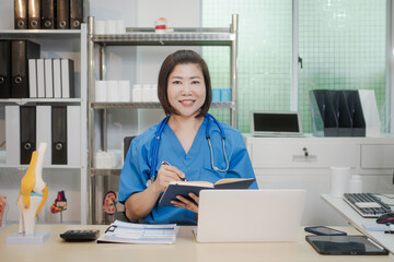 A middle-aged Asian female doctor at her desk,explaining various bone and joint diseases like...