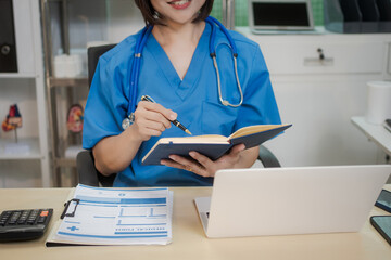 A middle-aged Asian female doctor at her desk,explaining various bone and joint diseases like...