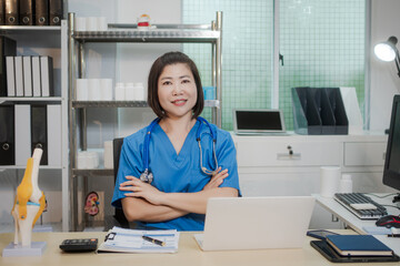 A middle-aged Asian female doctor at her desk,explaining various bone and joint diseases like...