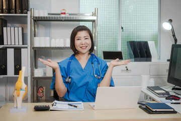 A middle-aged Asian female doctor at her desk,explaining various bone and joint diseases like...