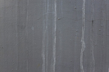 Close Up Of Textured Exterior Wall Featuring Discoloration From Water Runoff