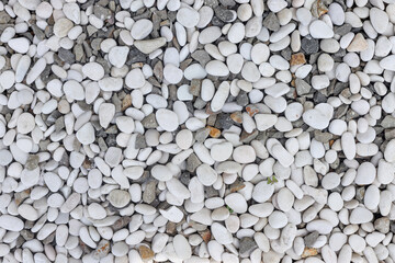 Top View Of Textured Surface Covered In Mix Of Smooth White And Rough Grey Pebbles