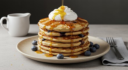 Golden Syrup Drizzles Over a Stack of Fluffy Blueberry Pancakes Topped with Whipped Cream