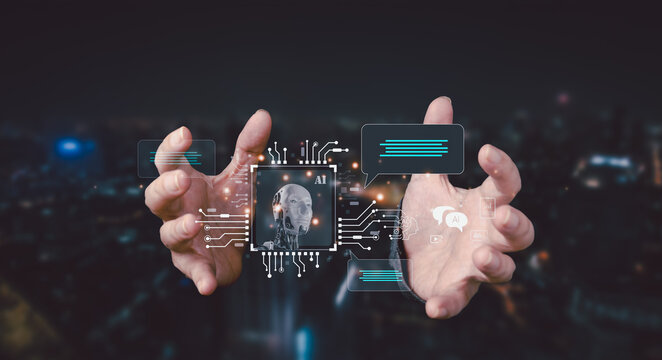 AI chatbot interaction concept. Two hands present a holographic interface featuring an AI robot head, circuit board, and chat bubbles over a city night view, signifying advanced communication.