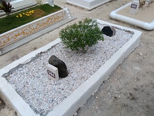 Muslim malay cemetary new grave   with river stones tomnbstones, Photo taken in Malaysia
