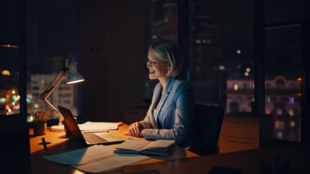 Late worker video calling laptop sitting business office closeup. Smiling woman