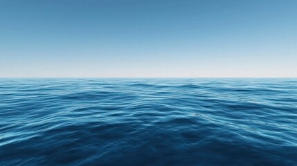 A vast expanse of calm blue ocean with gentle waves and a clear sky in the background.