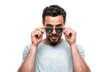 Confident man lowering sunglasses with stylish look and cool facial expression isolated on transparent background