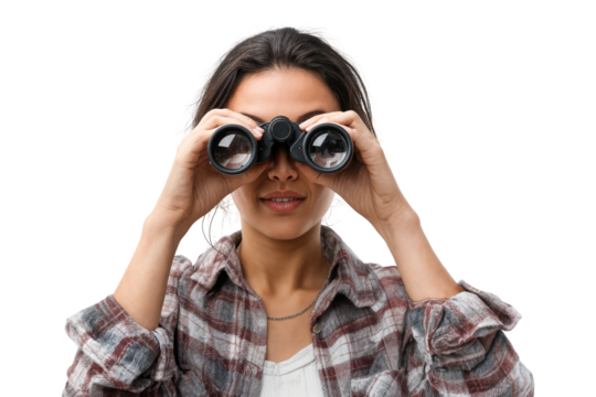 Smiling young woman looking through binoculars isolated on transparent background with curious and adventurous expression