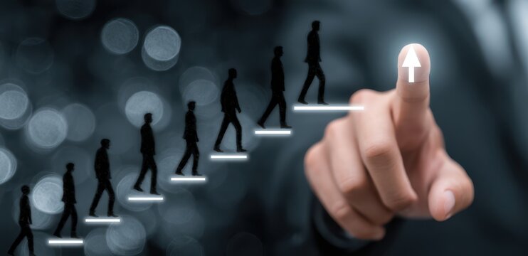 Silhouette figures ascending a stairway, progress, career growth