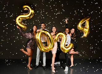 Happy beautiful multiethnic millennials men and woman in nice outfits celebrating New Year 2024...