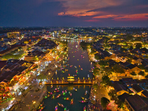 Aerial view of Hoi An old town or Hoian ancient town in evening. Royalty high-quality free stock image top of Hoai river and boat tour night traffic. One of the most popular touristic destination - Powered by Adobe