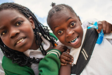 Premium close-up of happy African schoolchildren in uniforms, laughing together outdoors. A powerful and uplifting image capturing real joy, childhood, and cultural connection.