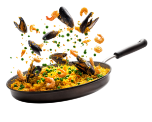 Traditional Spanish seafood paella with shrimp mussels and saffron rice flying from black pan isolated on transparent background