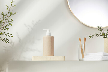 Soap dispenser and toothbrushes in minimalist bathroom with leafy shadows. Clean lines and sunlight...