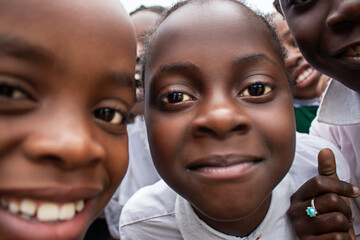 Premium close-up of happy African schoolchildren in uniforms, laughing together outdoors. A powerful and uplifting image capturing real joy, childhood, and cultural connection.