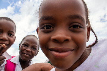 Premium close-up of happy African schoolchildren in uniforms, laughing together outdoors. A powerful and uplifting image capturing real joy, childhood, and cultural connection.