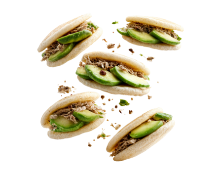 Tender bao buns with shredded beef and cucumber slices floating in the air with herbs isolated on transparent background