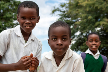 Premium close-up of happy African schoolchildren in uniforms, laughing together outdoors. A powerful and uplifting image capturing real joy, childhood, and cultural connection.