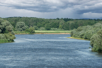 Big blue river in a green forest.