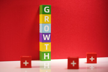 stack of toy blocks with text Growth against red background