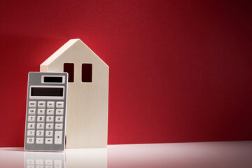 Calculator and model house made of wood.