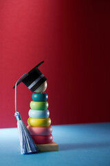 multi color toddler stacking toy with small mortarboard