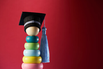 multi color toddler stacking toy with small mortarboard