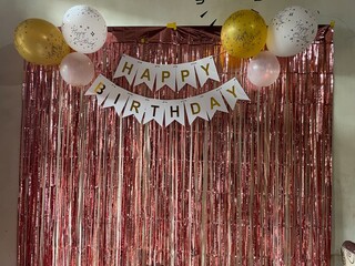 simple birthday decoration for a one year old child with a pastel pink theme, backdrop of foil...