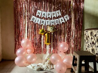 simple birthday decoration for a one year old child with a pastel pink theme, backdrop of foil...