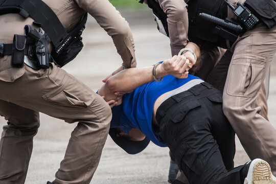 "Police Catch the Culprit",Police steel handcuffs,Police arrested,Professional police officer has to be very strong,Officer Arresting.