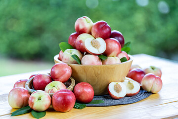 Sweet fruit, fresh Red Nectarine on a natural green background.