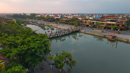 Fototapeta premium Drone image capturing Hoi An Ancient Town’s scenic streets, rooftops, and riverfront. UNESCO World Heritage Site with rich cultural heritage. Perfect for travel, tourism, and architecture content
