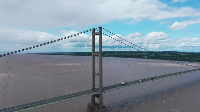 Humber bridge in hessle crossing a wide river under cloudy skies, aerial view