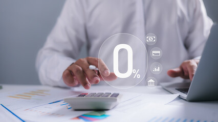 A person using a calculator and laptop with a prominent 0% icon overlay, representing zero interest rates, financial incentives, loan offers, and strategic cost management in banking and finance.