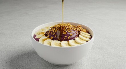 Golden Honey Drizzles Over a Vibrant Acai Bowl, Topped with Banana and Granola