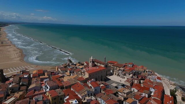 Circling the Cathedral Santa Maria della Purificazione near the sea, old town Termoli, Italy. Aerial