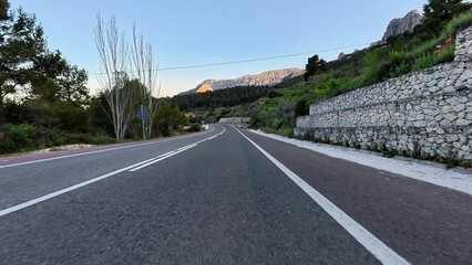 Explore a captivating winding road surrounded by beautiful landscapes and serene vistas, ideal for...