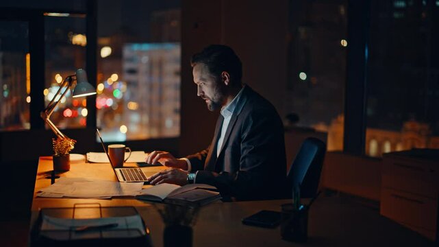 Angry executive watching screen in evening workspace. Upset worker slamming desk