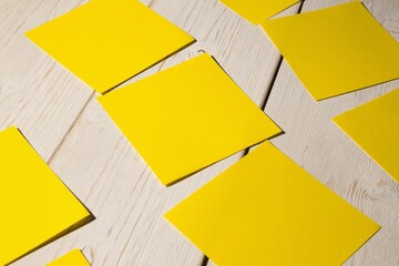 Square shaped papers on wooden floor