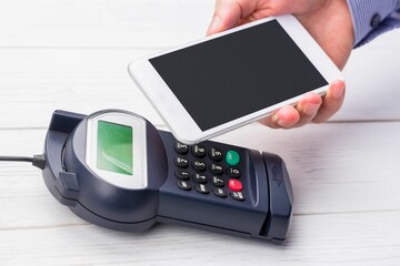 Man using smartphone to express pay