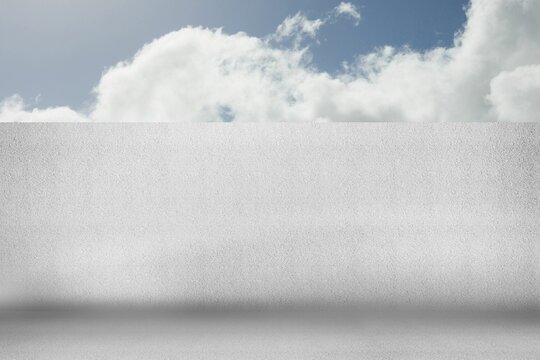 Fototapeta Flat design is showing blank white stucco wall and concrete floor under blue sky with clouds