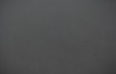 Medium-dark grey textured surface is showing shading variations and scuff marks in flat design