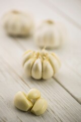 Garlic cloves and bulb on wooden surface
