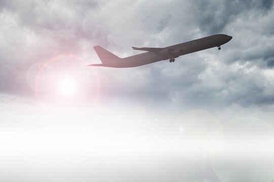 Fototapeta Airplane flying above clouds