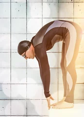 Fototapeten Male swimmer preparing to dive off starting block © vectorfusionart
