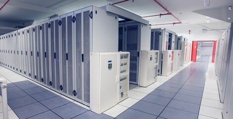 Flat design data center is showing white control cabinet with server racks under fluorescent lamps