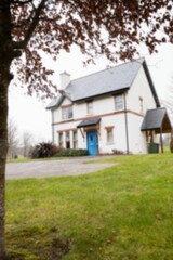 White house with lawn against sky