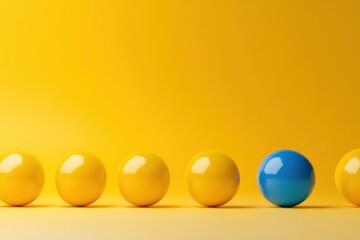 Creative concept of uniqueness and leadership with blue ball guiding yellow balls, minimal design